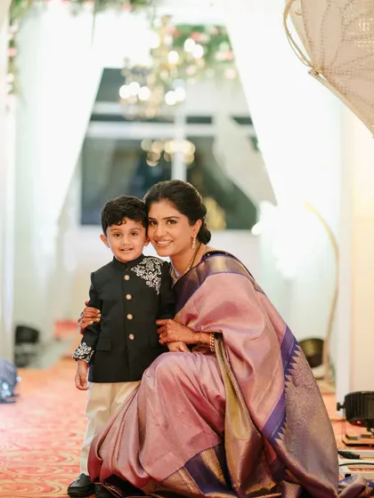 A picture-perfect moment between a mother and her son. Her makeup is soft, natural, and radiant, allowing her happy glow to be the focus.
