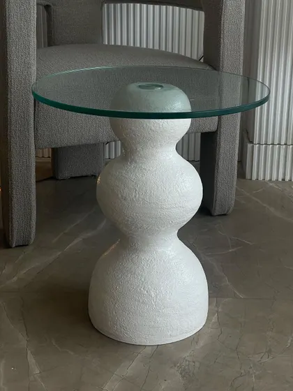 This handmade accent table embodies the wabi-sabi aesthetic with its imperfect, sculptural form and heavily textured finish. Paired with a glass top, it adds an element of organic, artistic craft to any minimal or Japandi-style interior.