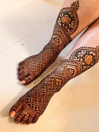 A modern take on bridal feet henna. This design uses a combination of geometric jaal patterns and shaded roses, extending up the leg for a unique and stylish look.