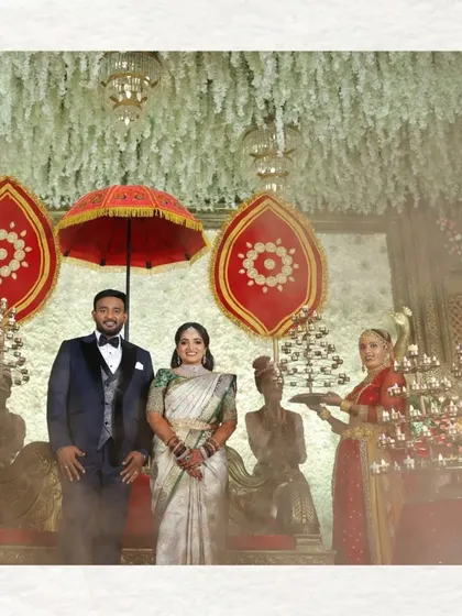 A grand stage portrait from a wedding reception. We capture the scale and beauty of the decor, with the couple at the center of the magnificent celebration.