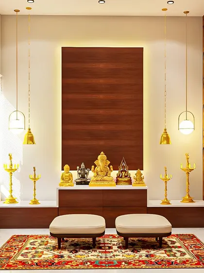This serene pooja space uses a simple wooden backdrop, elegant pendant lamps, and a beautiful traditional rug to create a calm and minimalist area for prayer.