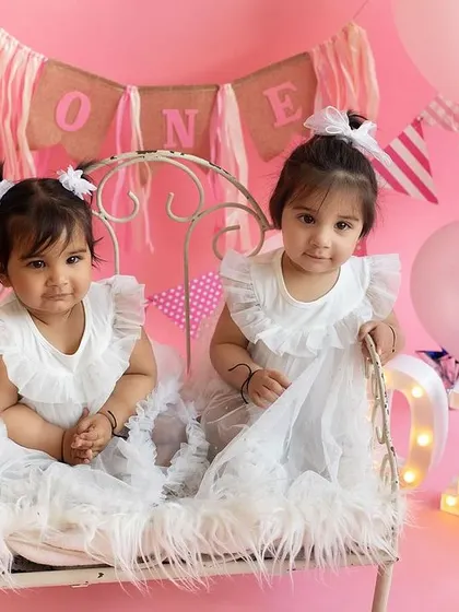 Another shot of the twin sisters in their pink wonderland. It's double the love and double the fun on set!