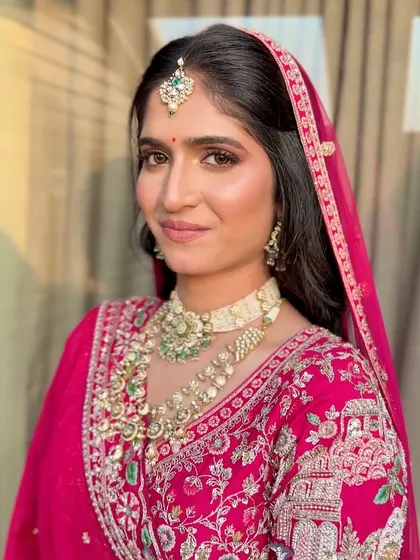 A classic bridal portrait, showing the complete look with the dupatta set perfectly.