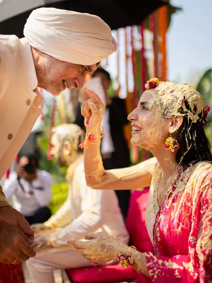 A father's blessing during the Haldi ceremony. We design events that honor these deep-rooted family traditions and emotional connections.