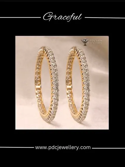 A graceful pair of 20-pointer single-line diamond bangles in 14kt hallmarked gold. This is a classic and versatile piece for any jewellery collection.