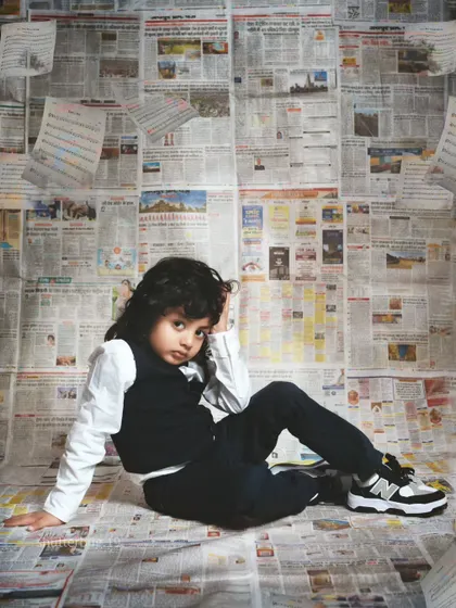 A relaxed, candid pose from a five-year-old boy, showing off his natural charm and personality.