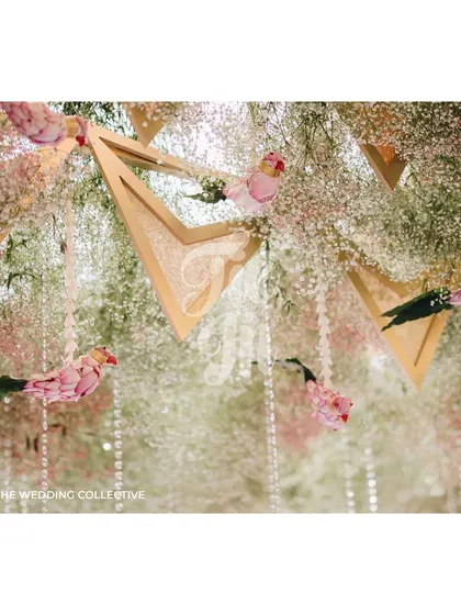 Looking up, the ceiling was a masterpiece of stepped geometric triangles, adorned with silk brocade fabrics in an ombre pattern. This detail, along with hanging baby's breath and crystal elements, added a touch of airy, dreamlike elegance to the ceremony.