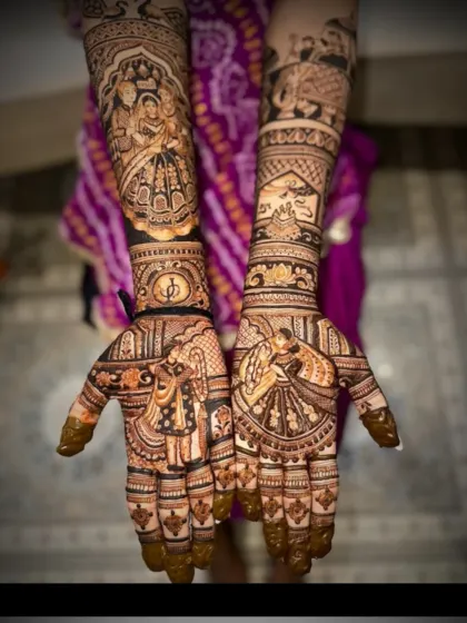 This intricate bridal mehendi features a dancing couple on the palms. The forearms are adorned with a bride's portrait and a scene from a traditional ceremony.