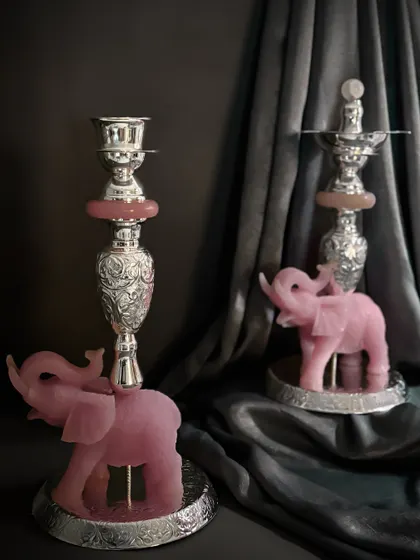 Here, I combine the gentle energy of rose quartz with the strength of metal. These unique candle stands feature elephants carved from natural stone, supporting ornate silver-toned holders that bring a ritual of grace and light to your space.