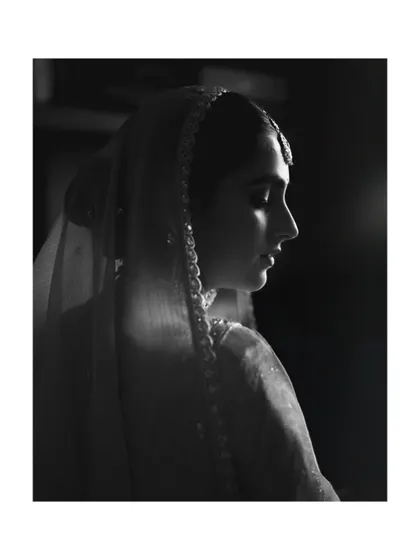 A dramatic black and white profile shot of the bride, capturing her grace and poise.