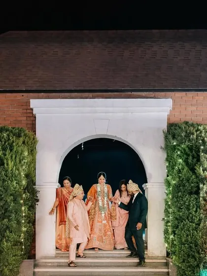 The bride's grand entrance to the party. This shot captures the excitement and anticipation as she makes her way to the celebration.