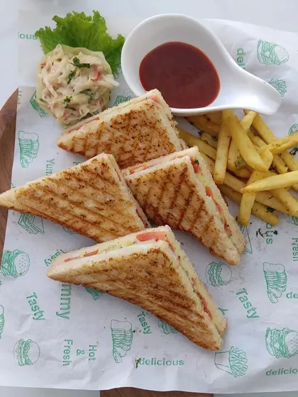 A classic club sandwich platter, served with french fries and coleslaw. A simple and satisfying option for casual events or kids' parties.