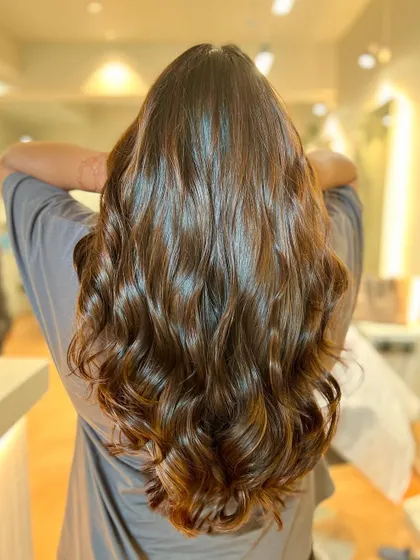 Our sunkissed caramel brown balayage adds warmth and dimension. It's a perfect way to get that natural, just-back-from-vacation glow.