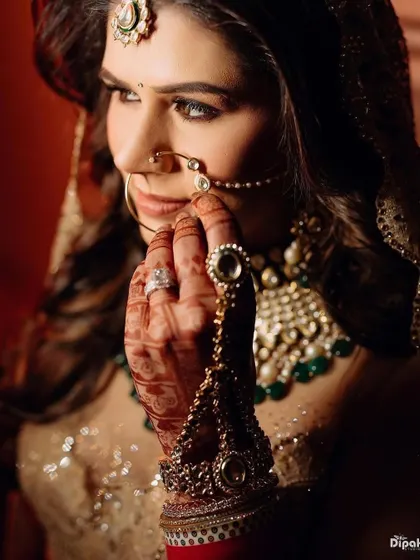 Another stunning shot of the bride, her hair perfectly complementing her intricate jewelry.