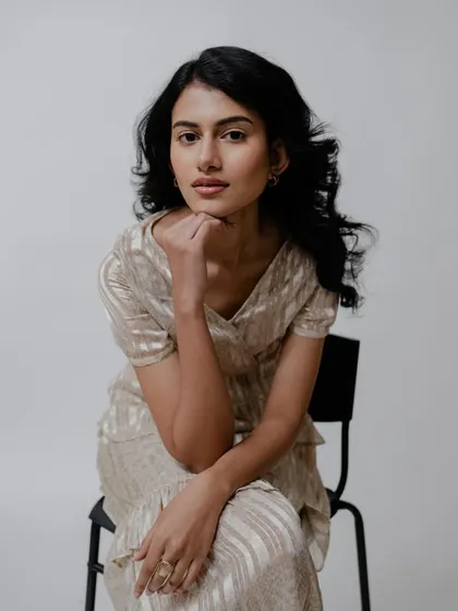 The clean makeup ensures the model's natural beauty is the focus, complemented by a simple, elegant hairstyle.