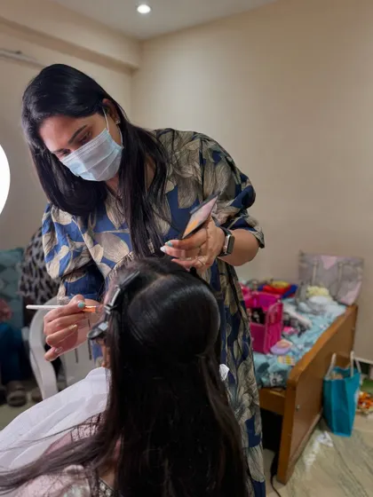 Another angle of me working on a bride, showing the focus and precision required for professional bridal makeup.