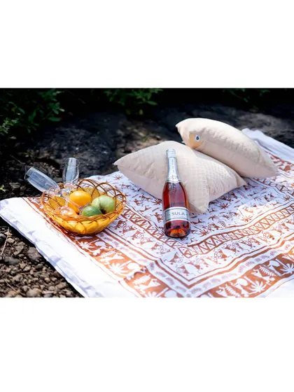 A detail shot of a romantic picnic setup for a pre-wedding shoot, complete with champagne and fresh fruit. We help plan these small details to make your shoot special.