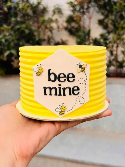 A "Bee Mine" mini cake for Valentine's Day. The bright yellow stripes and cute bees are so cheerful.