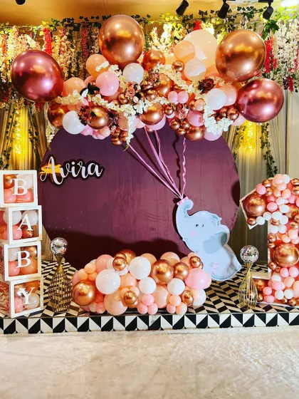 This elegant first birthday setup features a beautiful rose gold and pink color scheme. I used a custom backdrop with a cute elephant, balloon-filled "BABY" blocks, and a large number "1" mosaic for a sophisticated and memorable look.