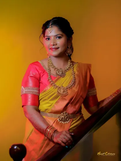 An engagement portrait of the bride-to-be. The warm lighting complements her yellow and pink saree beautifully.