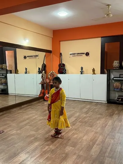 A young student stands ready in the center of our studio for her solo performance during the exam.