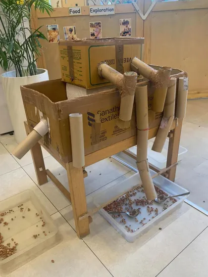 This homemade marble run, constructed from cardboard boxes and tubes, is a perfect example of a Reggio-inspired provocation. It invites children to explore gravity, momentum, and cause and effect using recycled materials.