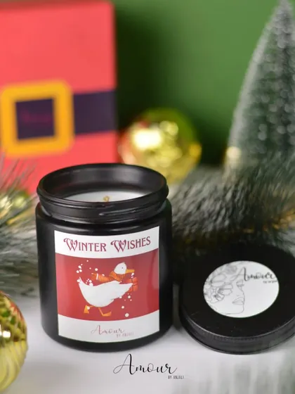 A close-up of the 'Winter Wishes' jar candle from my Christmas collection, featuring a cute goose design and a festive apple and clove scent.
