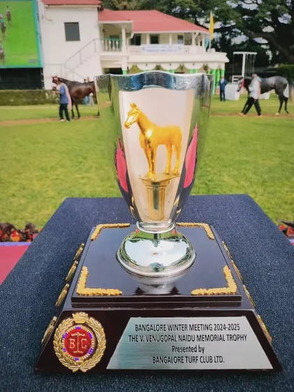 The V. Venugopal Naidu Memorial Trophy, a classic silver cup with a golden horse figurine.