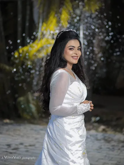 A full-length shot of a model in a beautiful white gown, showcasing a classic Christian wedding look with long, flowing hair.