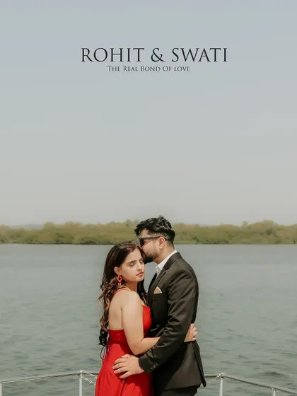 An elegant and romantic portrait on a yacht, with a tender forehead kiss and the open water as a backdrop.