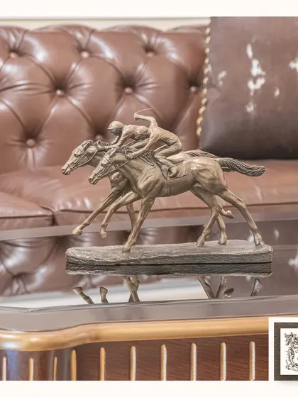 This dynamic sculpture of two racing horses captures a moment of speed and intensity. It's a perfect tabletop piece for adding energy and a love for equestrian sport to your decor.