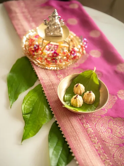 Another view of the Ganesh Chaturthi arrangement, with a focus on the silver Ganesha idol. The composition highlights the sacred elements of the festival.