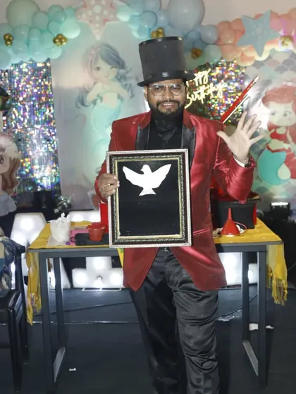 A classic pose with a dove picture frame illusion. This trick, where a picture of a dove comes to life, is a beautiful and artistic part of my show.
