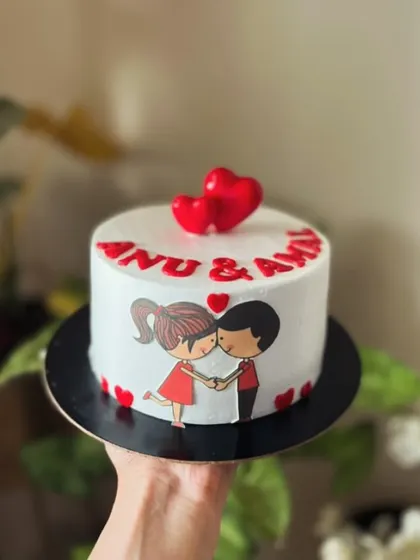 A mini cake for a couple, featuring a sweet cartoon illustration and 3D hearts on top.