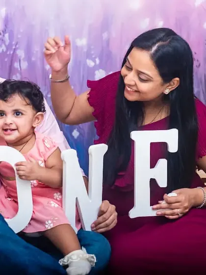 A lovely family portrait from a pre-birthday studio session. Using "ONE" letter props is a great way to mark the milestone, and the family's interaction makes the photo warm and genuine.