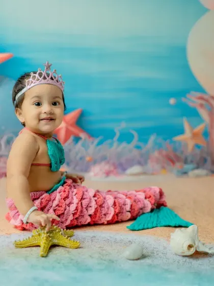 A sweet, smiling side profile as she plays with a starfish. These candid moments are precious.