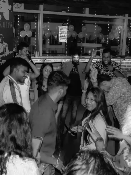 A black and white shot of the dance floor, capturing the movement and energy in a timeless way. The party is a blur of fun.