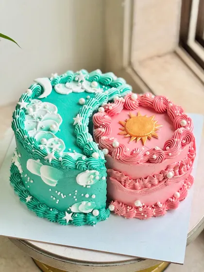 A different angle of the sun and moon cake, showing the intricate piping and the way the two distinct designs complement each other.