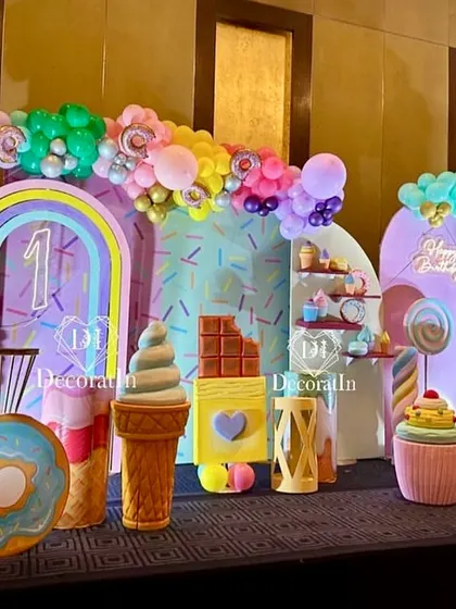A spectacular Candyland stage setup, filled with giant props of ice cream, donuts, chocolate bars, and cupcakes.