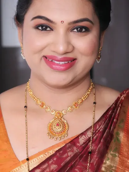 A smiling portrait of Bhanu, looking happy and radiant for her housewarming celebration.