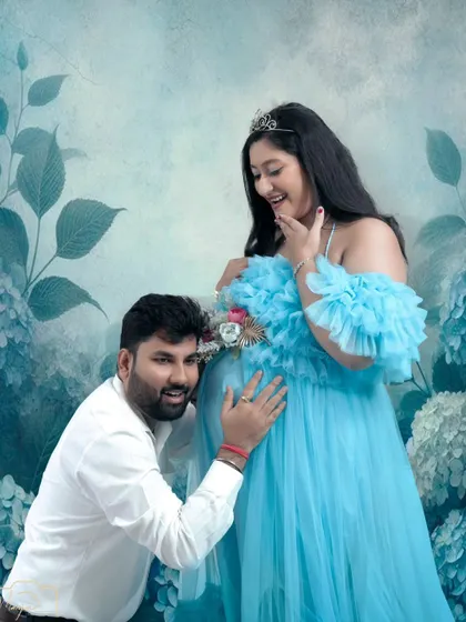 Listening for a heartbeat. This sweet, candid moment is made even more magical with the addition of a painted floral background.