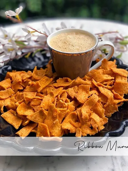 A plate of my crispy Ribbon Murukku served with coffee. This snack gets its name from its shape and is a lighter, yet equally flavorful, variation of the classic murukku.