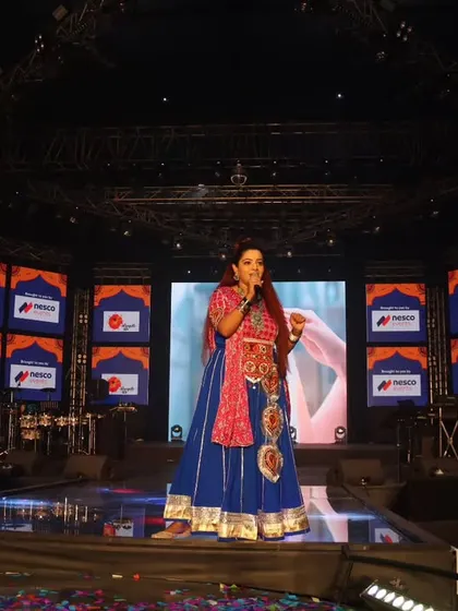 Commanding the expansive stage at 'Rangilo Re' on Day 7. This wide shot showcases the scale of the event and my comfort in being the focal point for a massive audience.