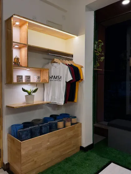 We keep our studio stocked with all the essentials. Here you can see our collection of yoga blocks and branded apparel, ready for our members.