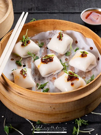 For these dimsums, I used a traditional bamboo steamer as a prop to create an authentic context. The lighting is soft, focusing on the delicate texture of the wrappers and the savory filling.