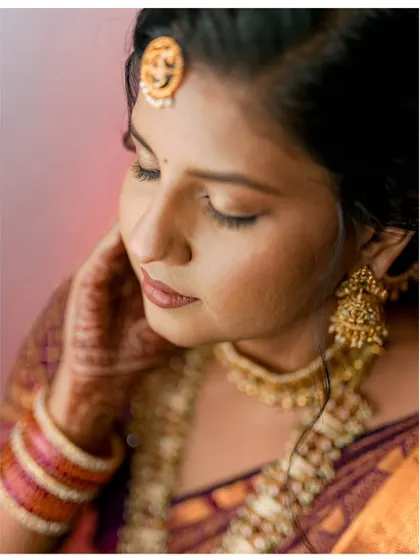 A serene and beautiful close-up of the bride-to-be on her engagement day, highlighting her traditional jewelry and makeup.