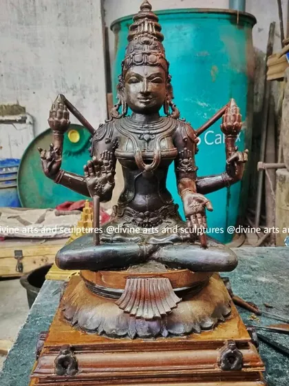 A wax model of Mahalakshmi in our workshop setting. The background shows the tools and materials of our trade, giving context to the patient, hands-on process of creating each divine form.