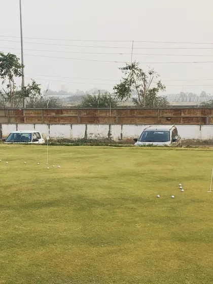 A quirky view of our new putting green, showing its proximity to the parking area and highlighting our unique location.