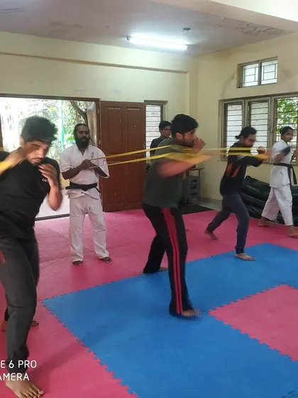 A wider view of the resistance band training, with me observing the students' form.