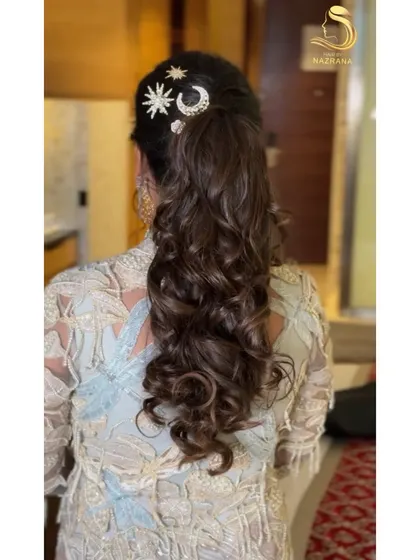 This voluminous ponytail is all about texture and glam. I added celestial-themed hair accessories to catch the light and add a whimsical touch to this party-ready style.